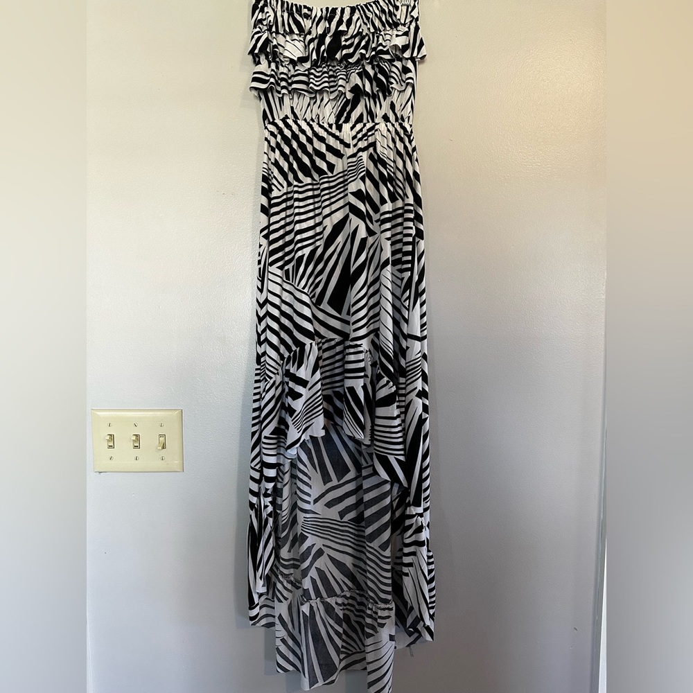 Sleeveless sundress with longer back skirt and ruffled bust.